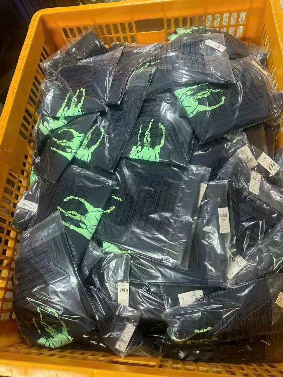 Packaged apparel SKUs in a factory handling bin